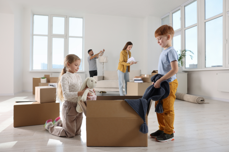 Family unpacking moving boxes