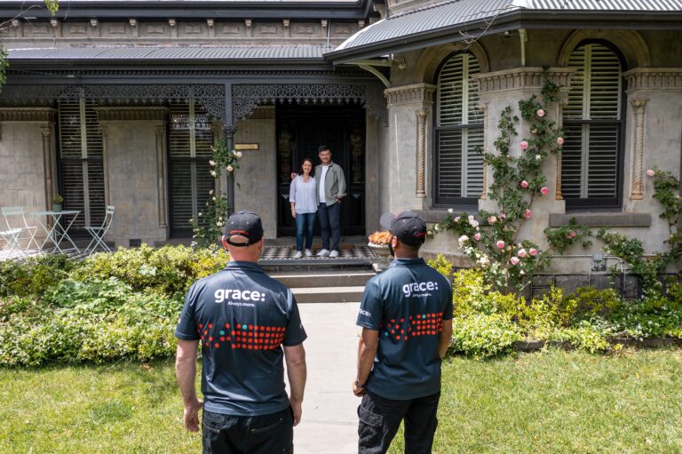 Removalists standing in-front of a home.